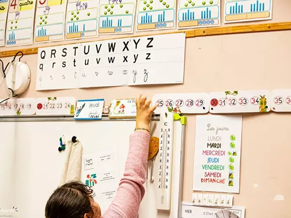 fille devant un tableau d'école